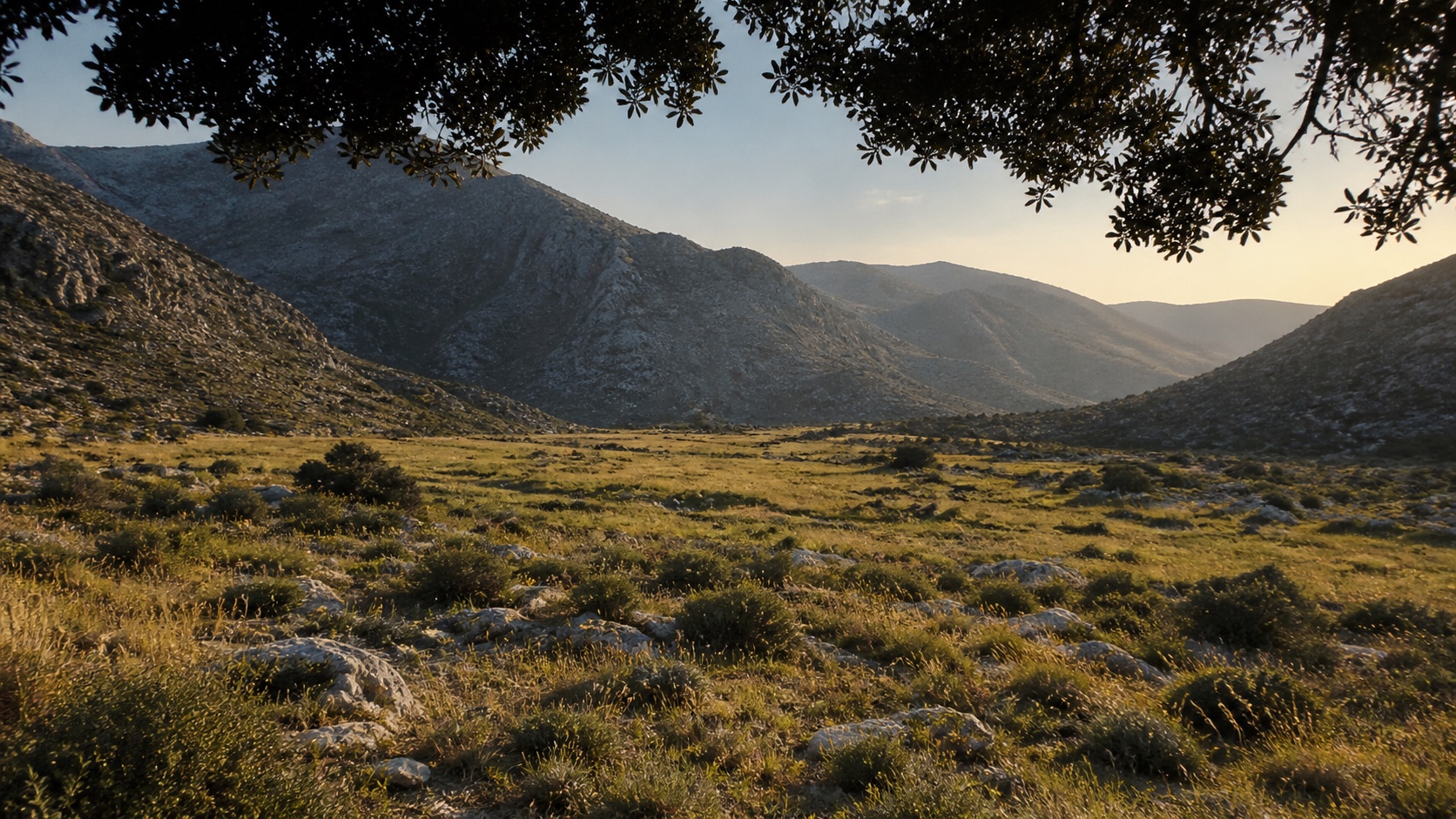 An unnamed grassy Cretan plain lies beneath rugged mountains and a dark canopy.